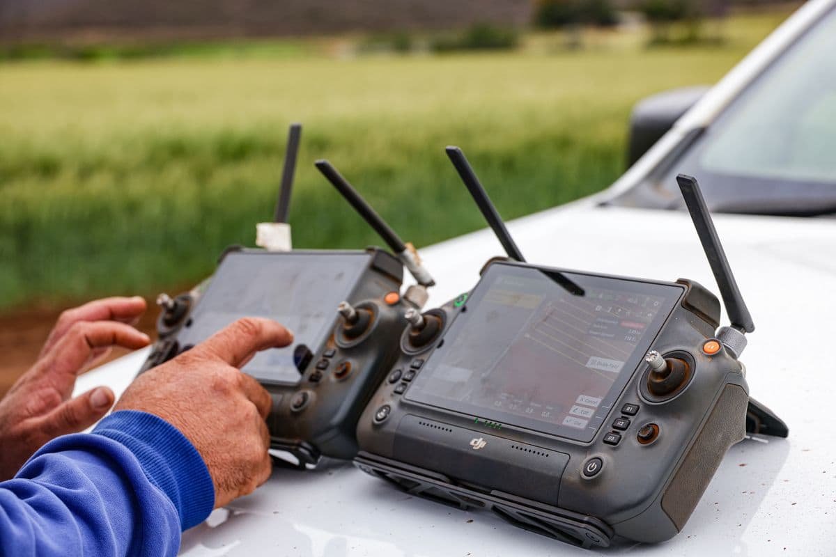Farmers using drone controllers for precision agriculture