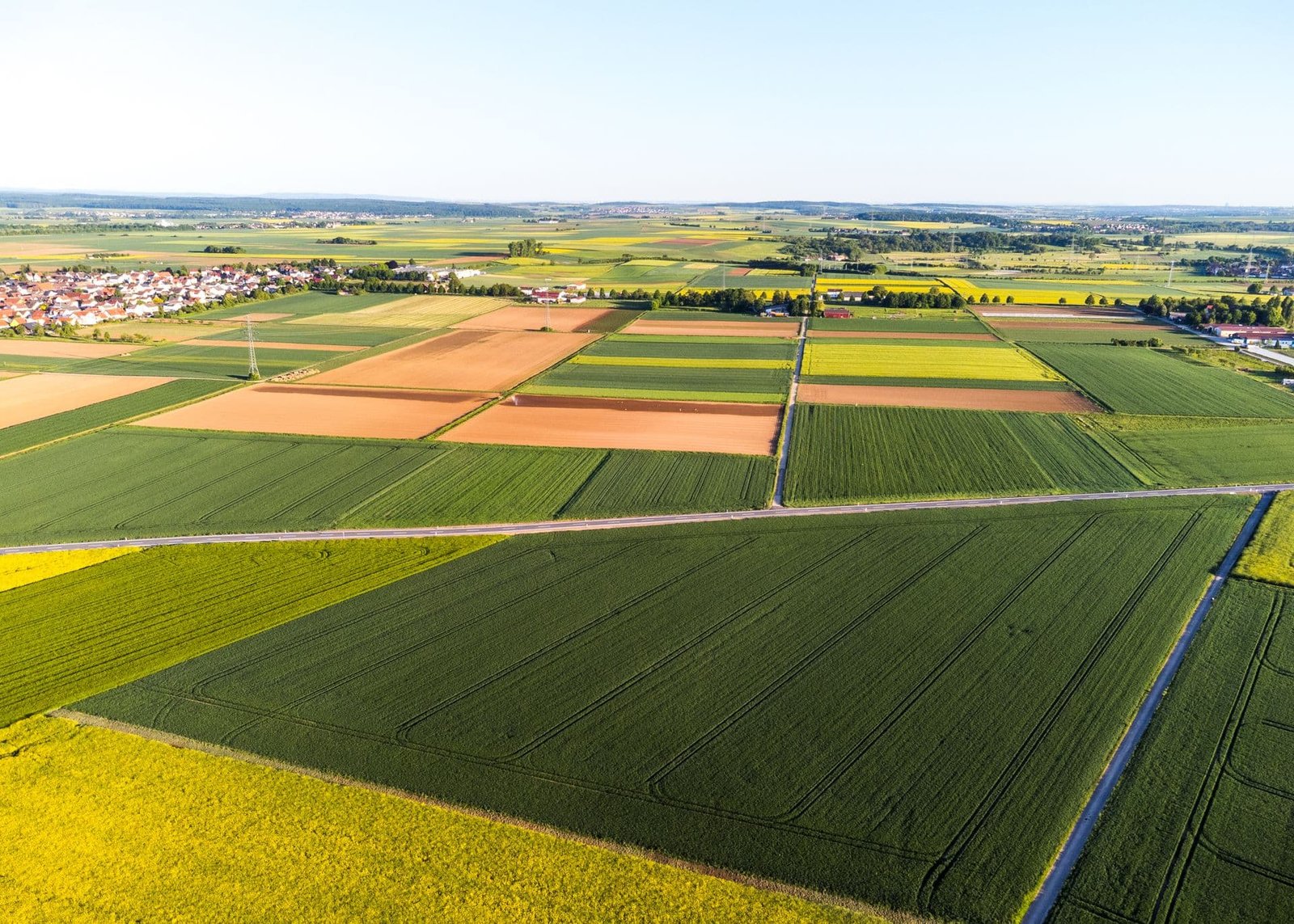 Aerial view of a patchwork of green and golden farm fields